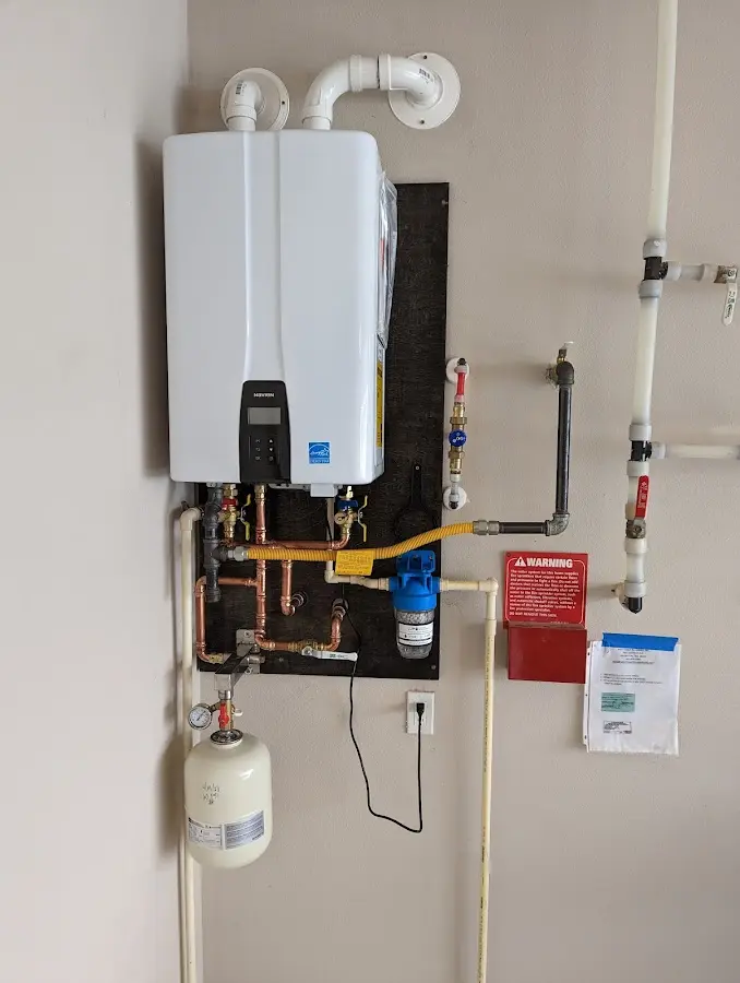 Professional plumber installing copper piping in a West Rockhill home